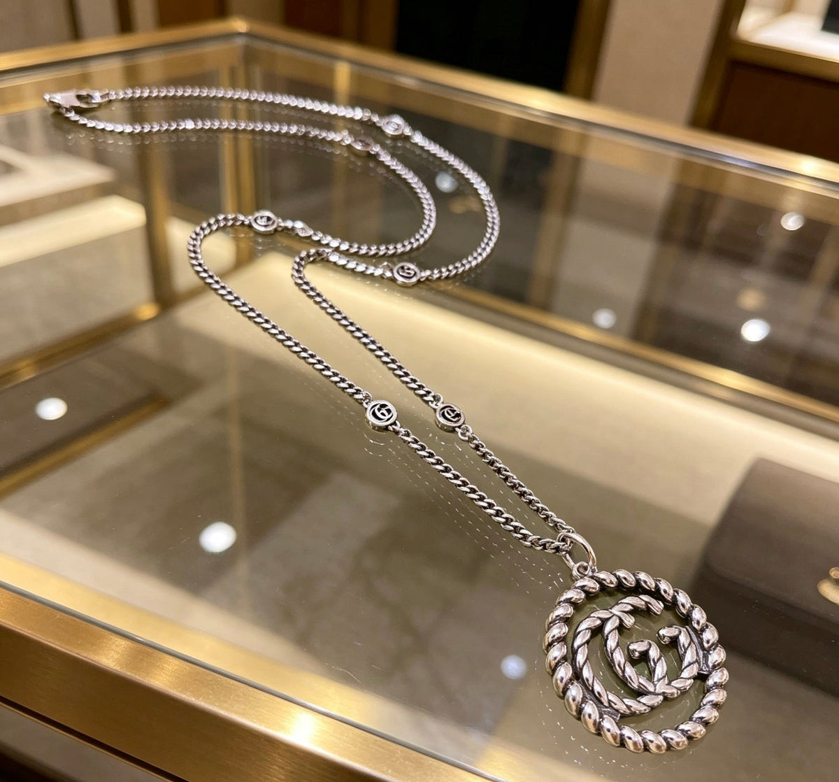 Martin Graham pendant necklace in polished metal-tone – detail view
