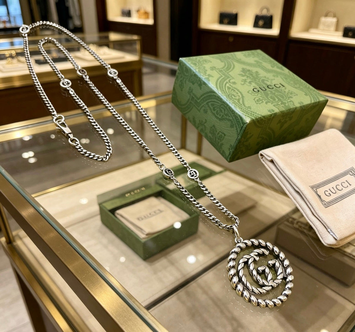 Martin Graham pendant necklace in polished metal-tone – close-up detail