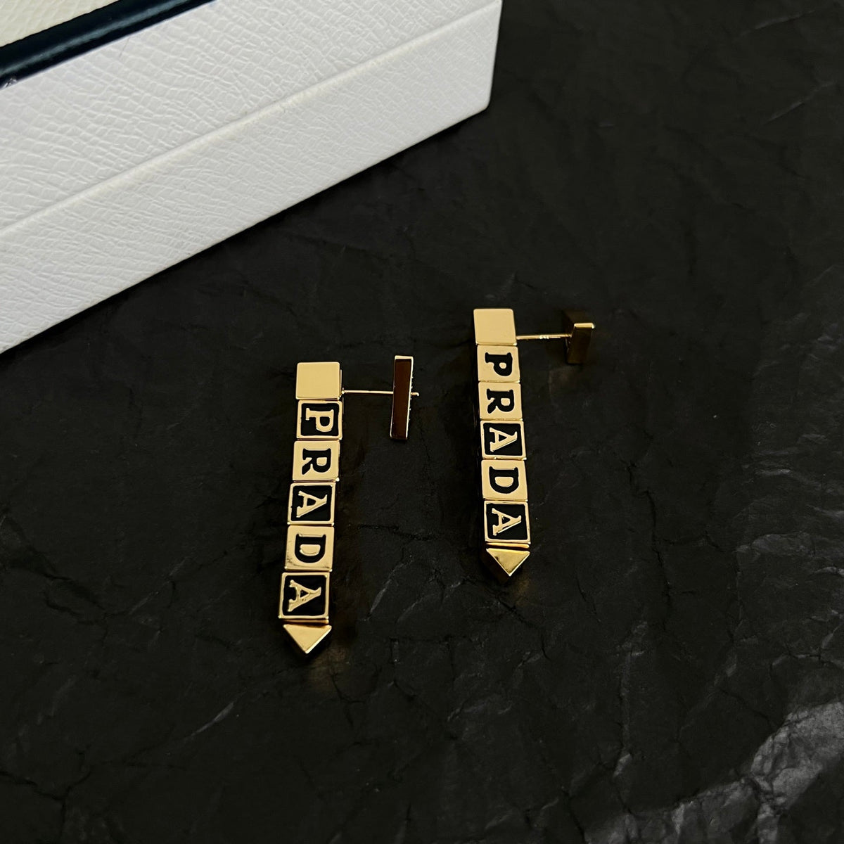 Martin Graham stud earrings in polished metal-tone – side detail