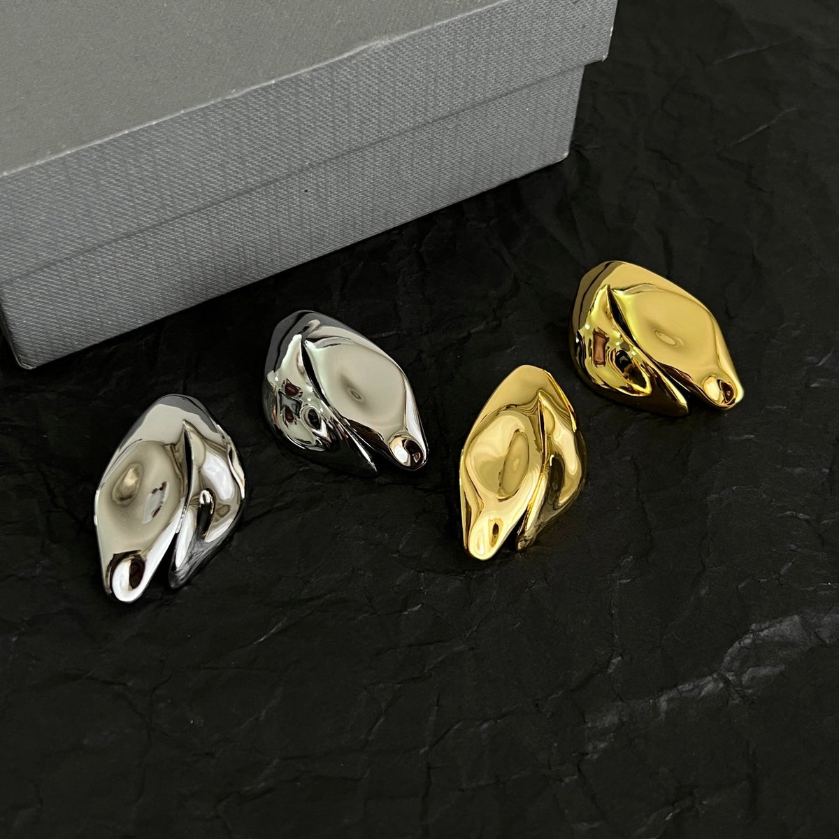 Martin Graham stud earrings in polished metal-tone – close-up detail