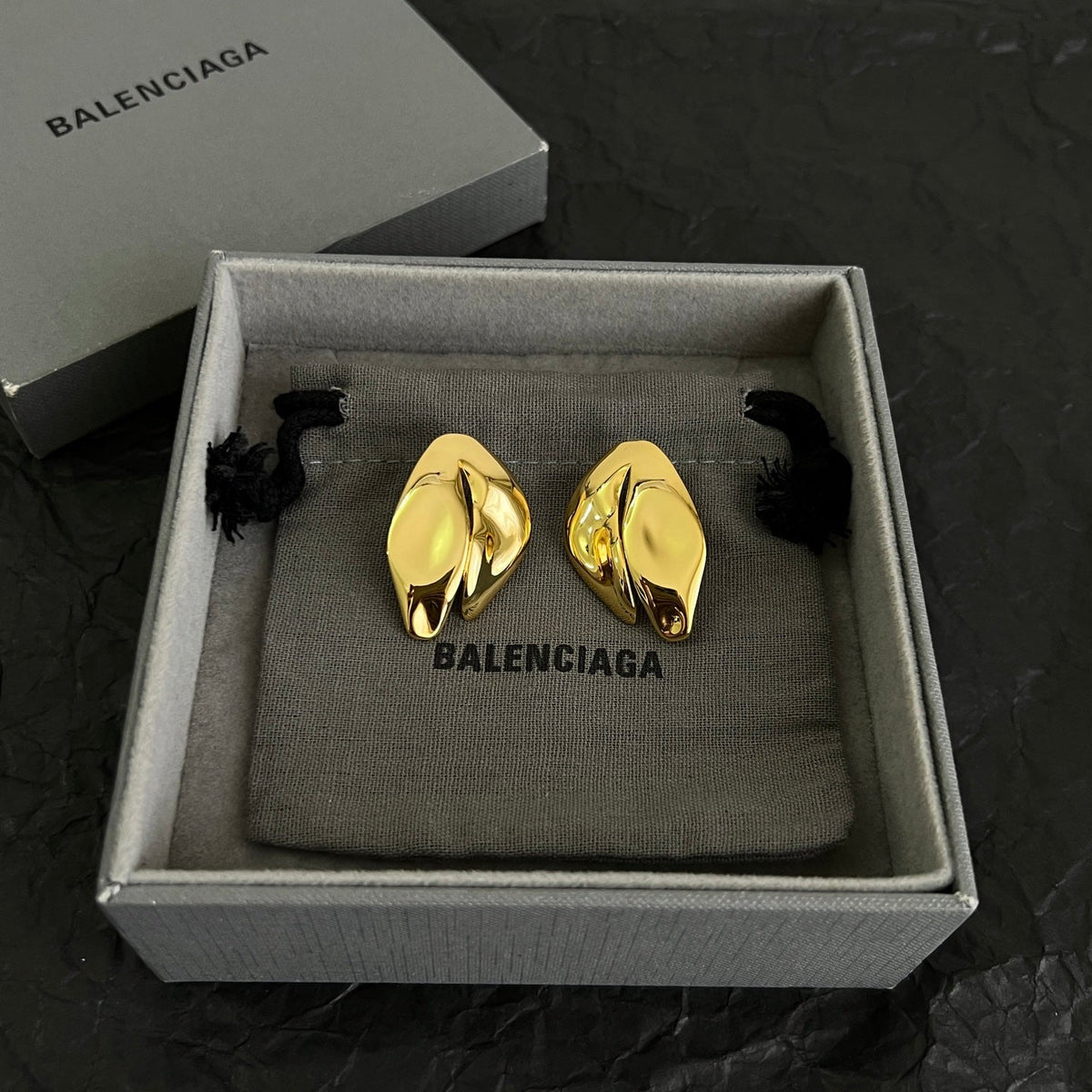 Martin Graham stud earrings in polished metal-tone – side detail
