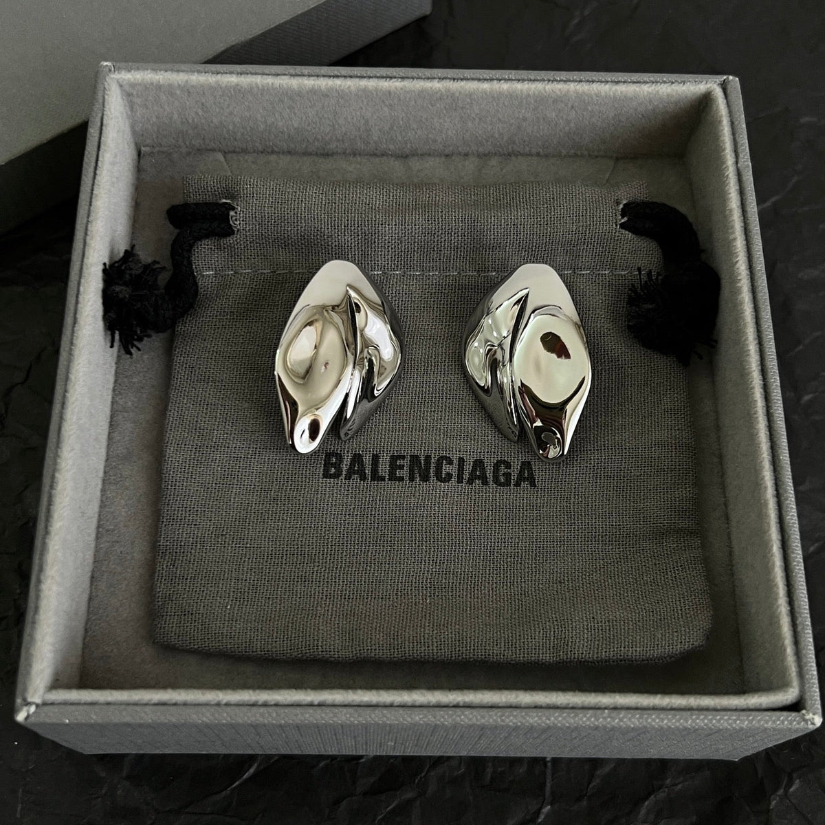 Martin Graham stud earrings in polished metal-tone – side detail
