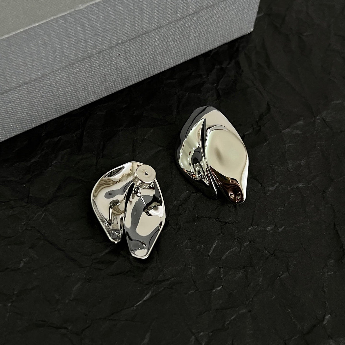 Martin Graham stud earrings in polished metal-tone – close-up detail