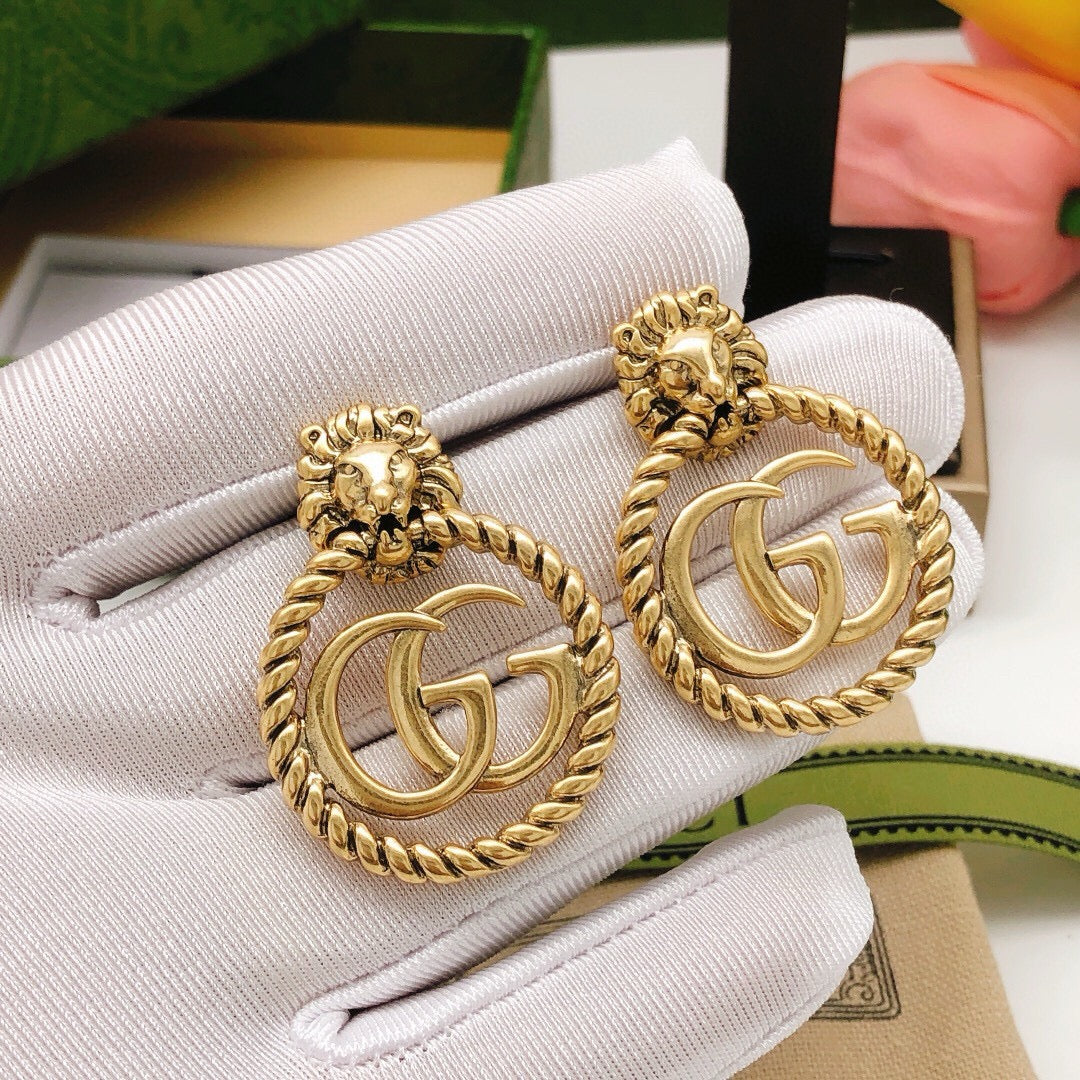Martin Graham stud earrings in polished metal-tone – front product view