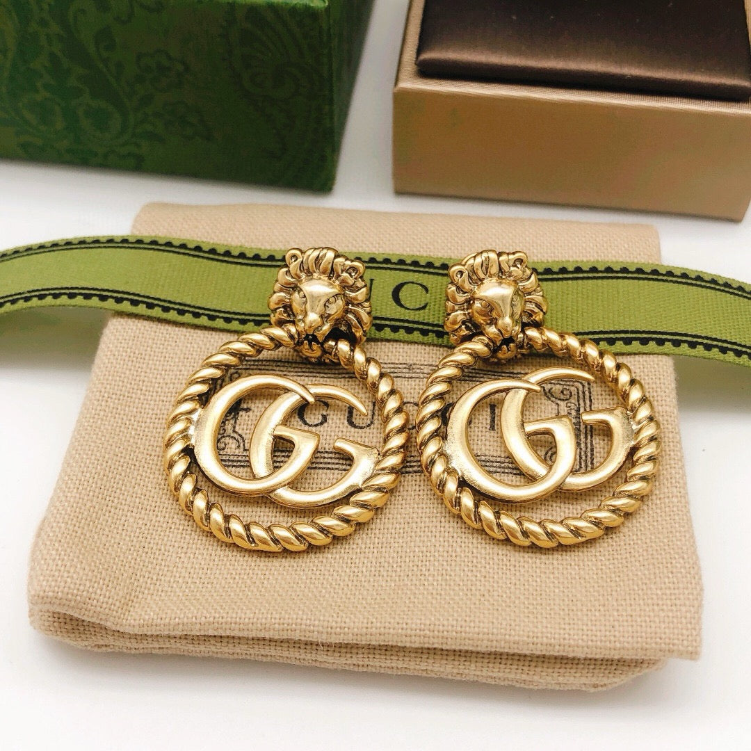 Martin Graham stud earrings in polished metal-tone – close-up detail