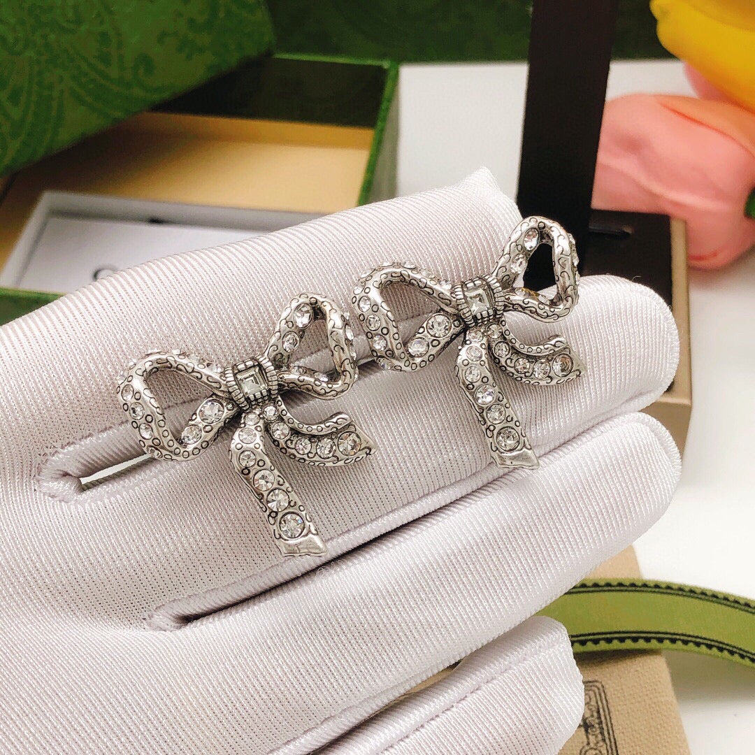 Martin Graham stud earrings in polished metal-tone – front product view