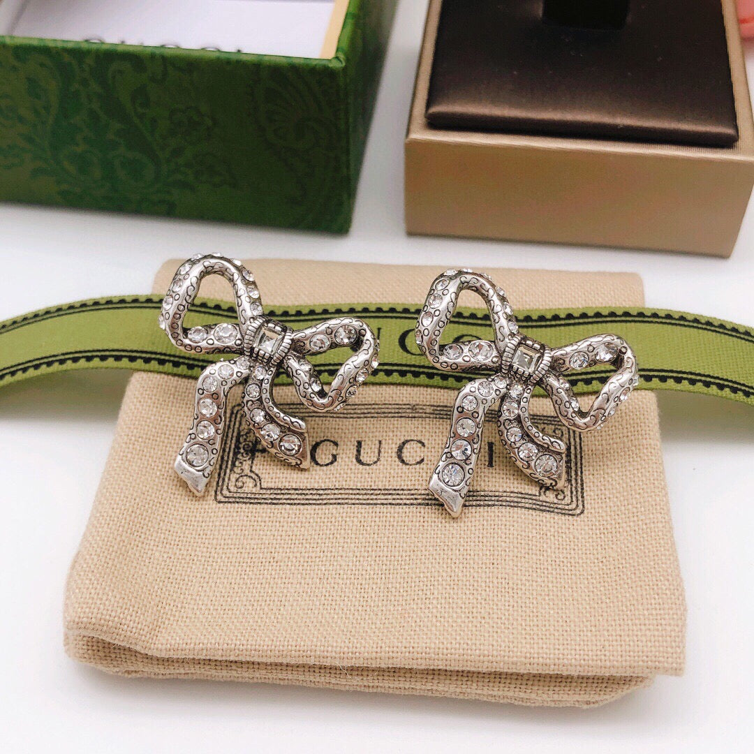 Martin Graham stud earrings in polished metal-tone – detail view