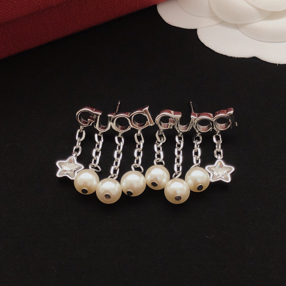 Martin Graham stud earrings in polished metal-tone – side detail
