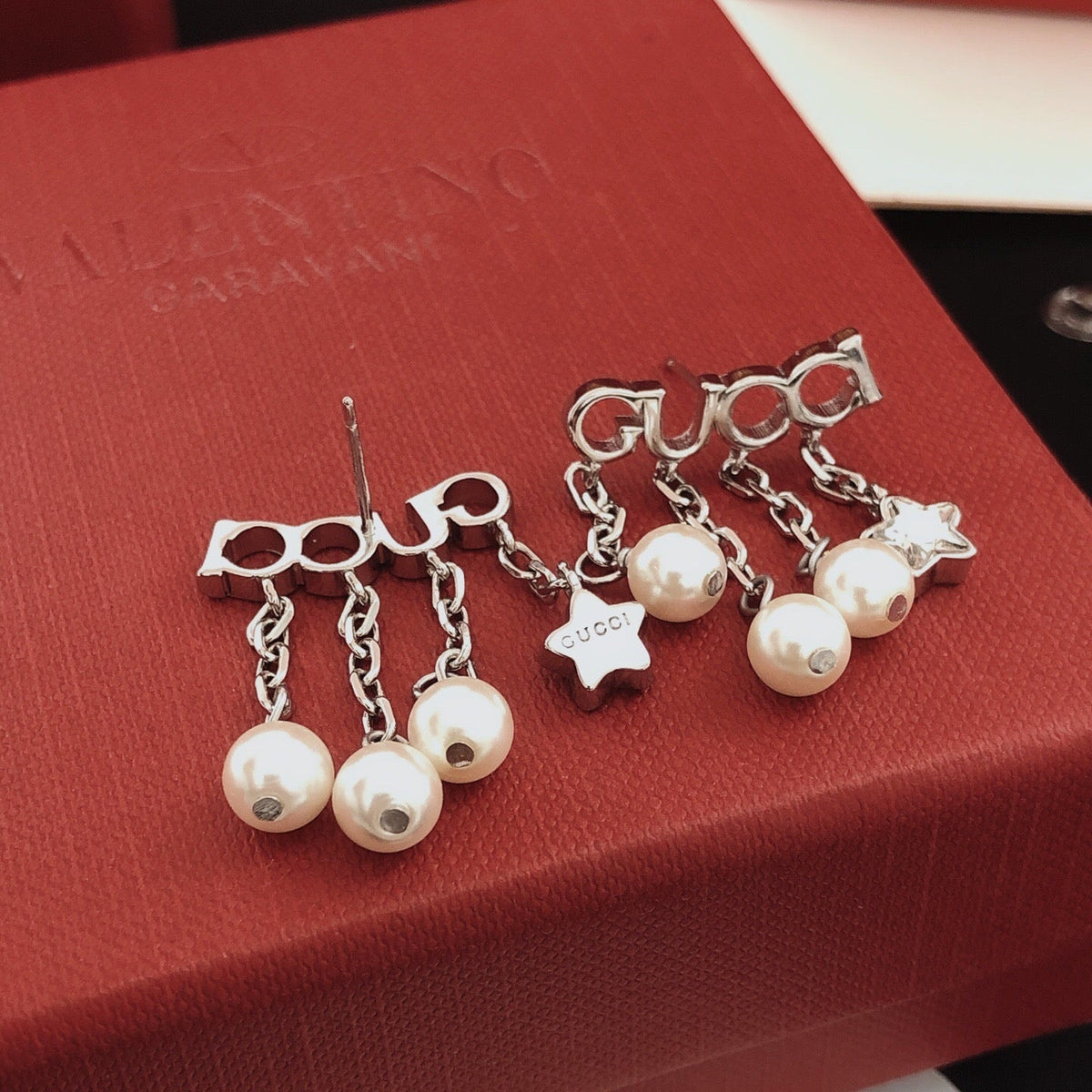Martin Graham stud earrings in polished metal-tone – close-up detail