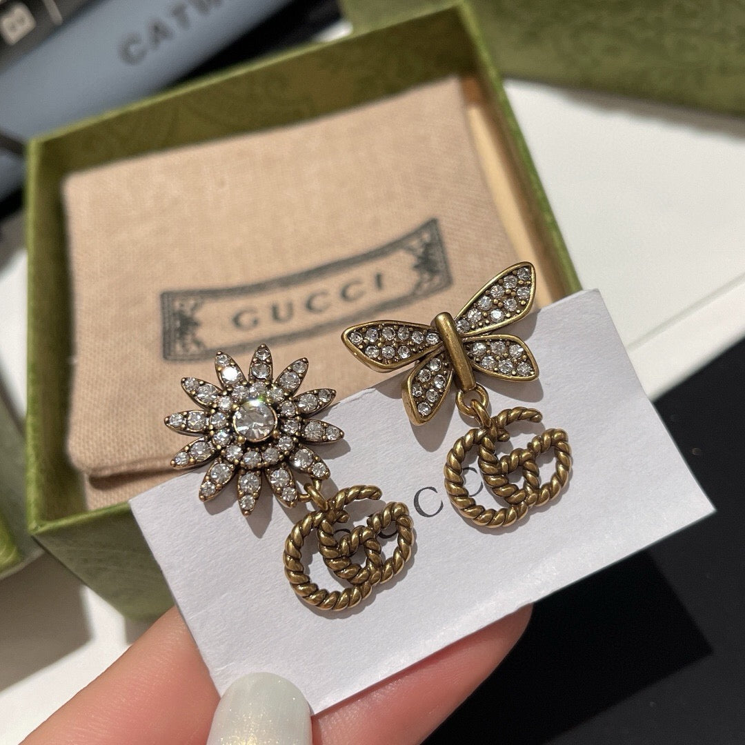 Martin Graham stud earrings in polished metal-tone – close-up detail