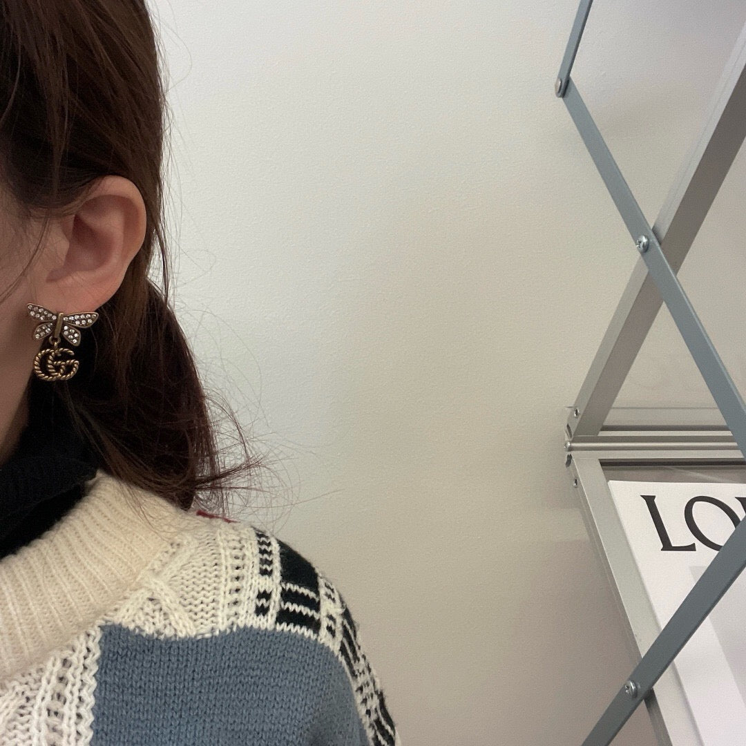 Martin Graham stud earrings in polished metal-tone – front product view