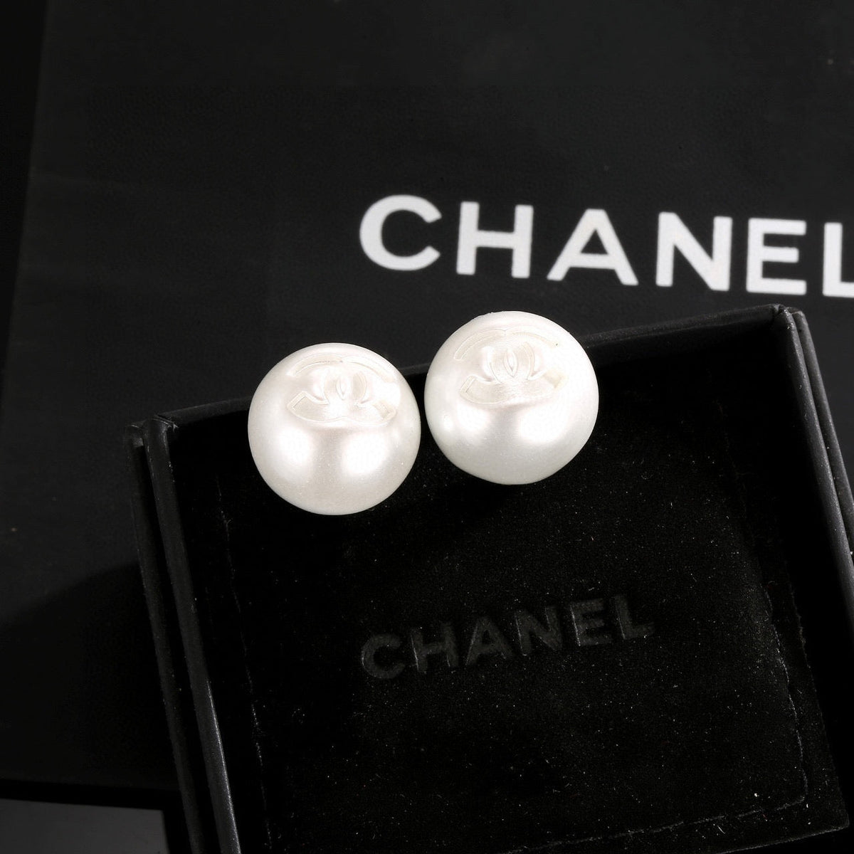 Martin Graham stud earrings in polished metal-tone – close-up detail