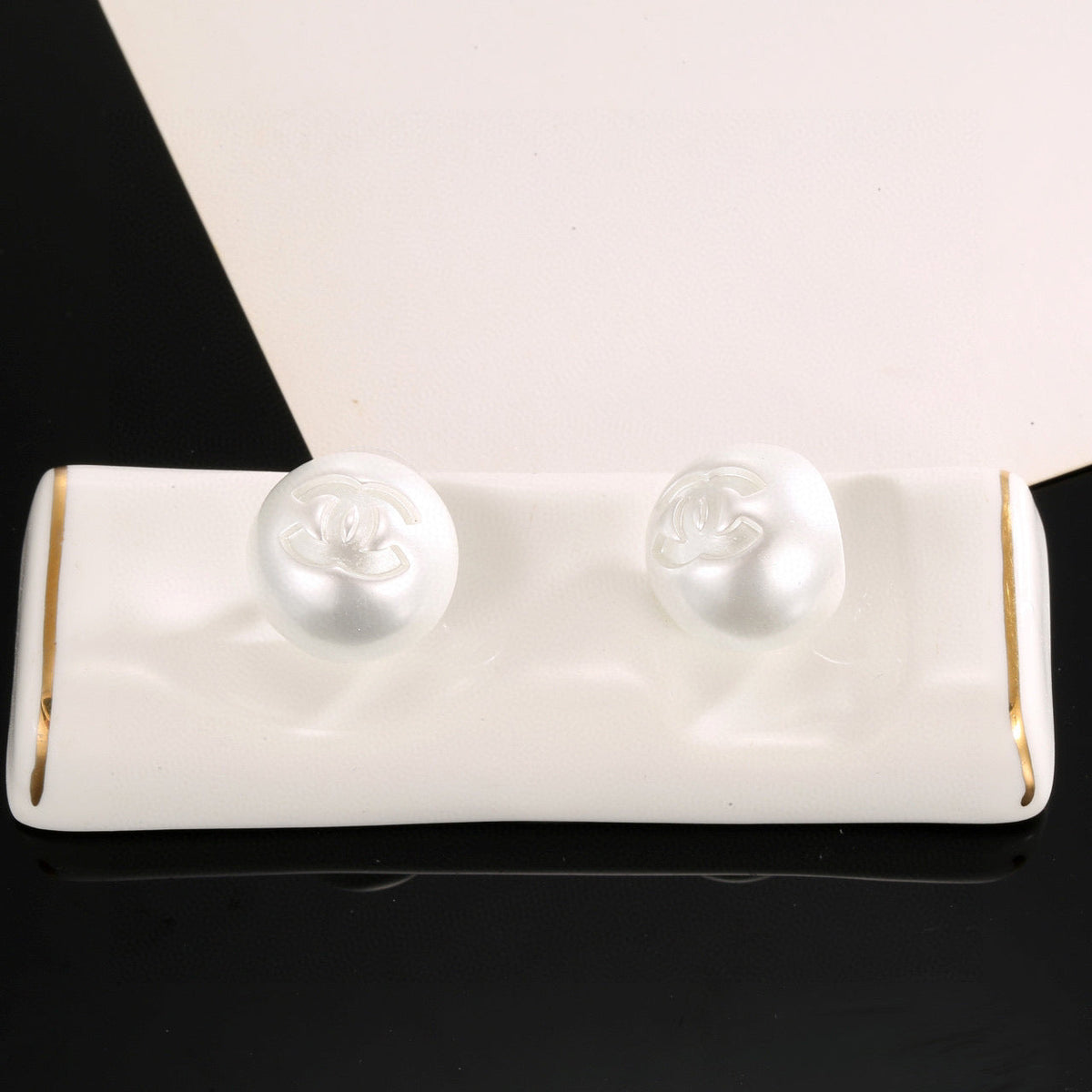 Martin Graham stud earrings in polished metal-tone – side detail