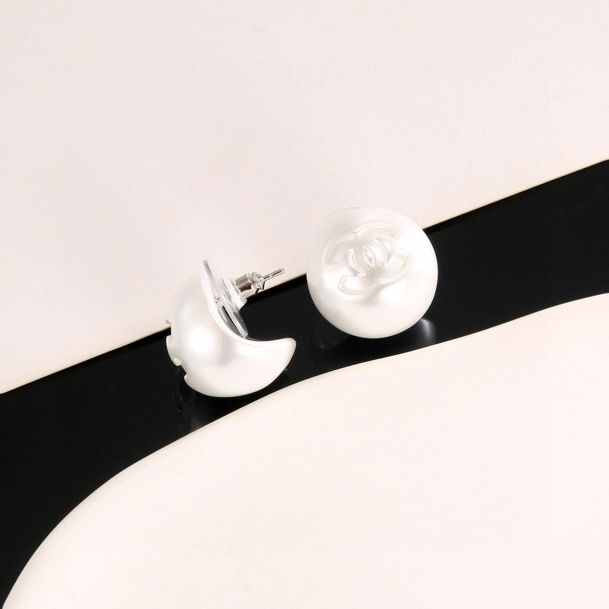 Martin Graham stud earrings in polished metal-tone – detail view