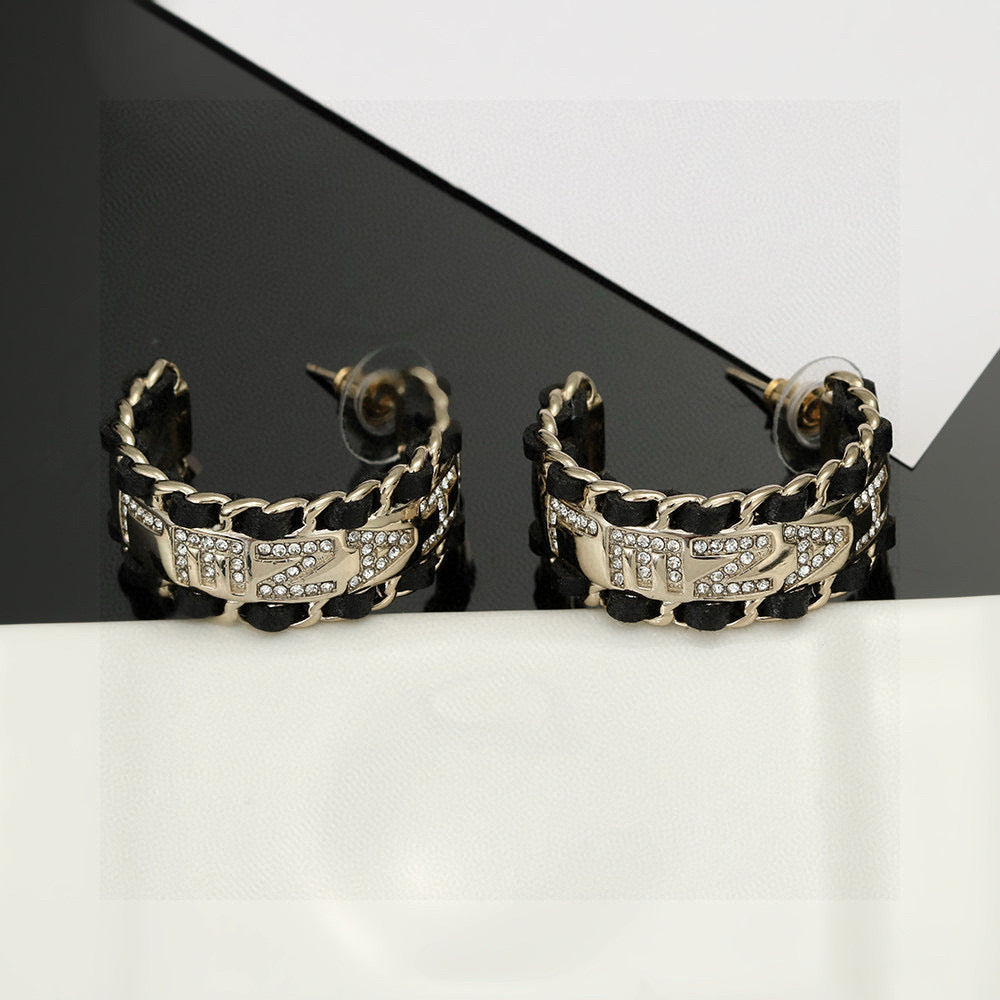 Martin Graham stud earrings in polished metal-tone – side detail