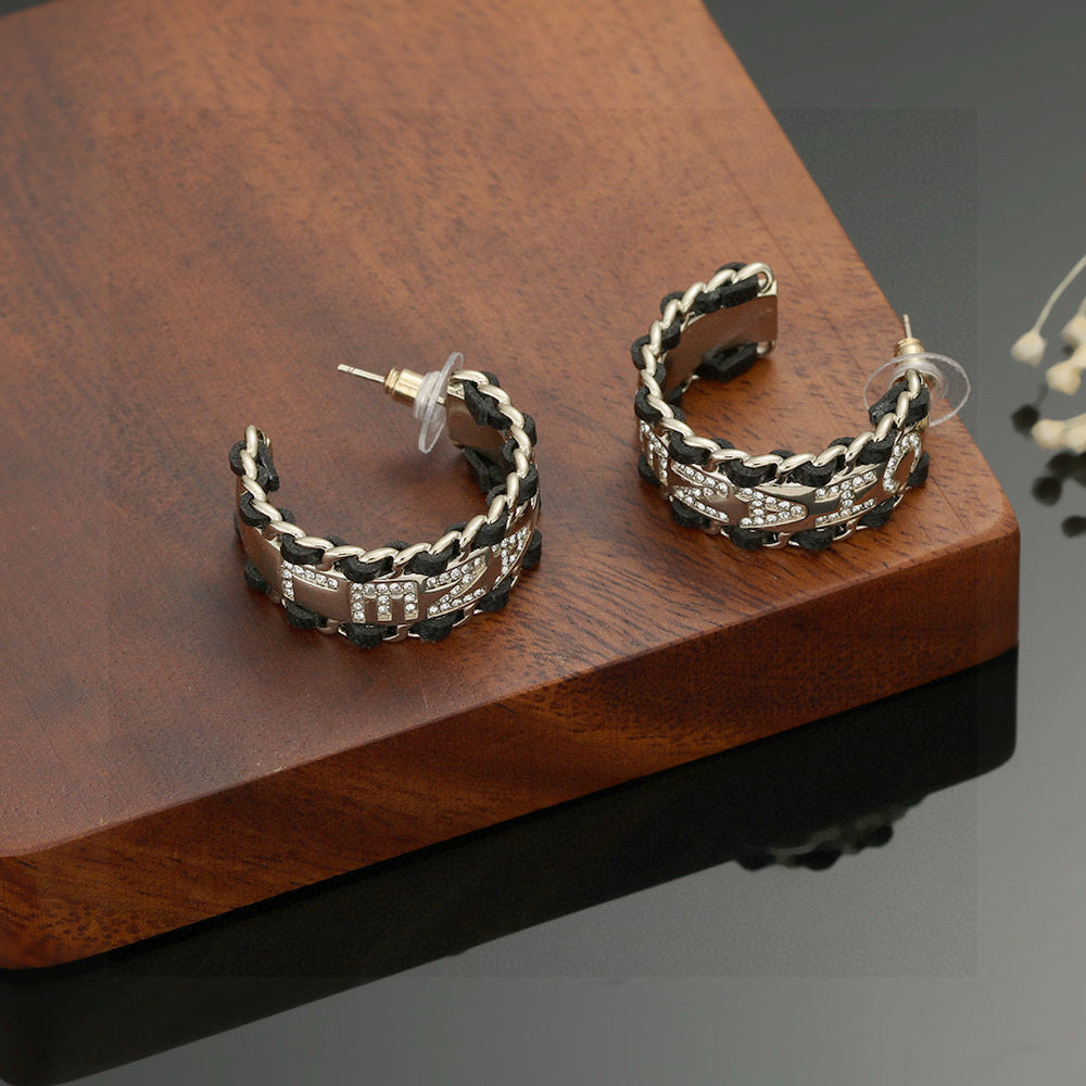 Martin Graham stud earrings in polished metal-tone – front product view