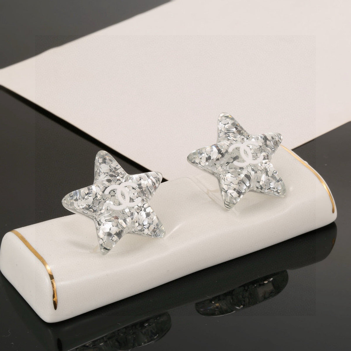 Martin Graham stud earrings in polished metal-tone – detail view