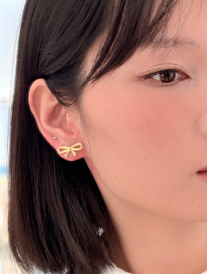 Martin Graham stud earrings in polished metal-tone – detail view