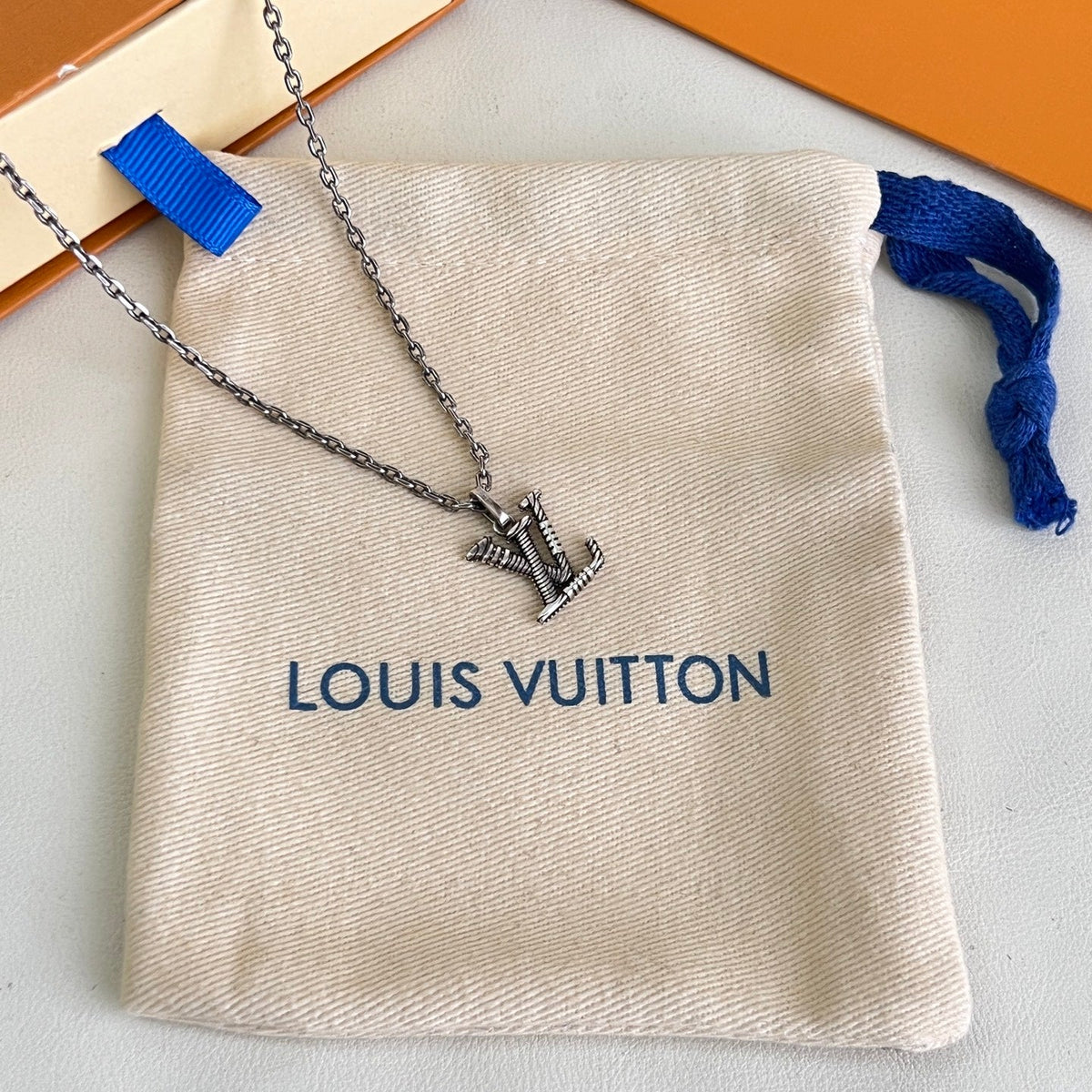 Martin Graham pendant necklace in polished metal-tone – close-up detail