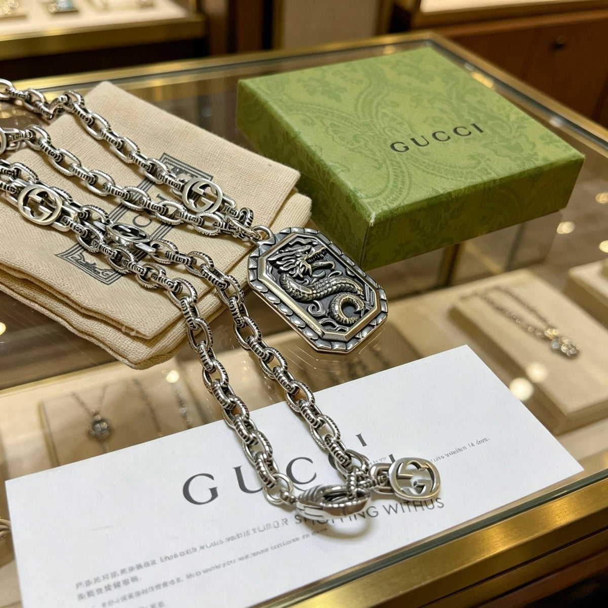 Martin Graham pendant necklace in polished metal-tone – close-up detail