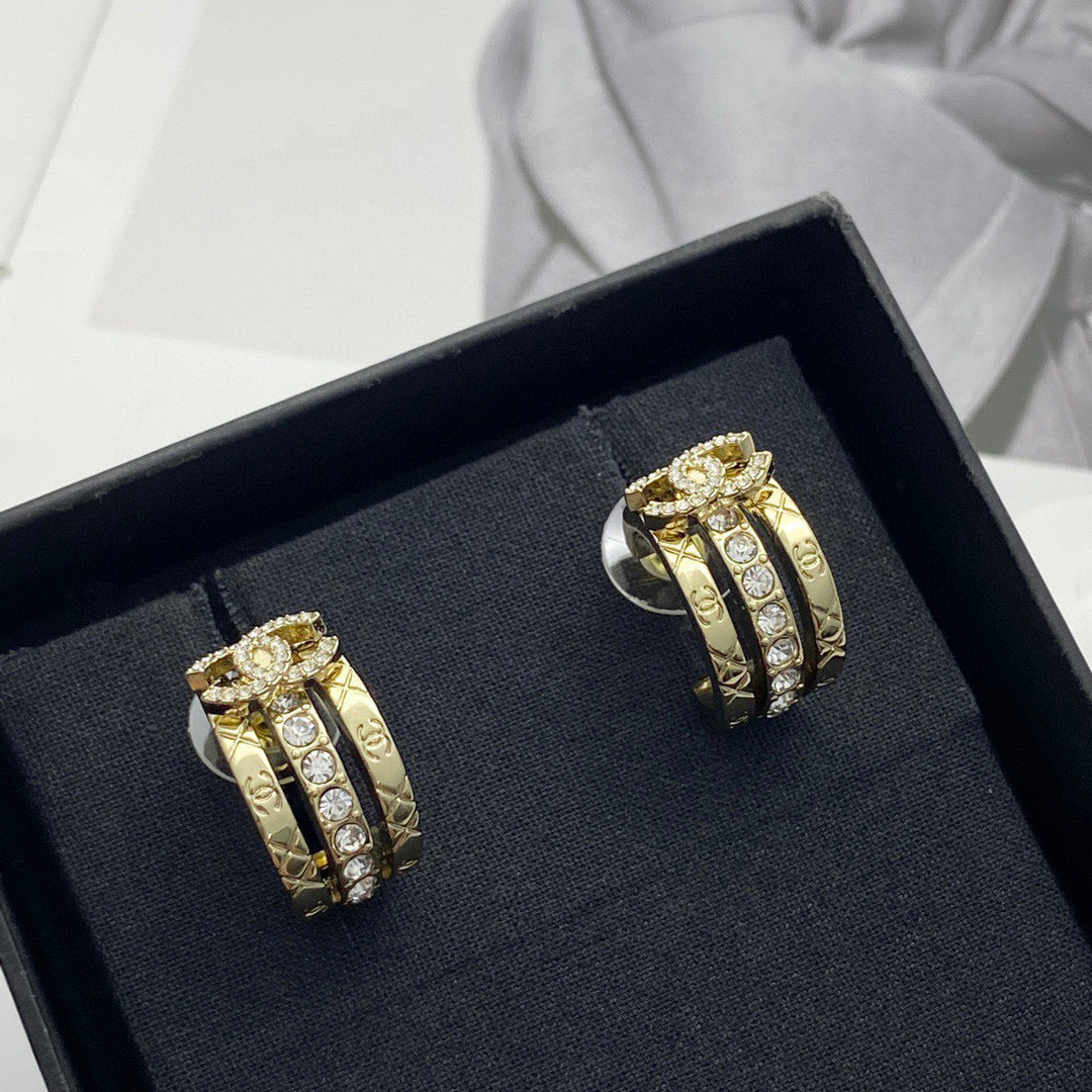 Martin Graham stud earrings in polished metal-tone – close-up detail