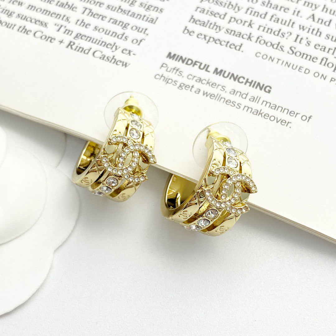 Martin Graham stud earrings in polished metal-tone – detail view