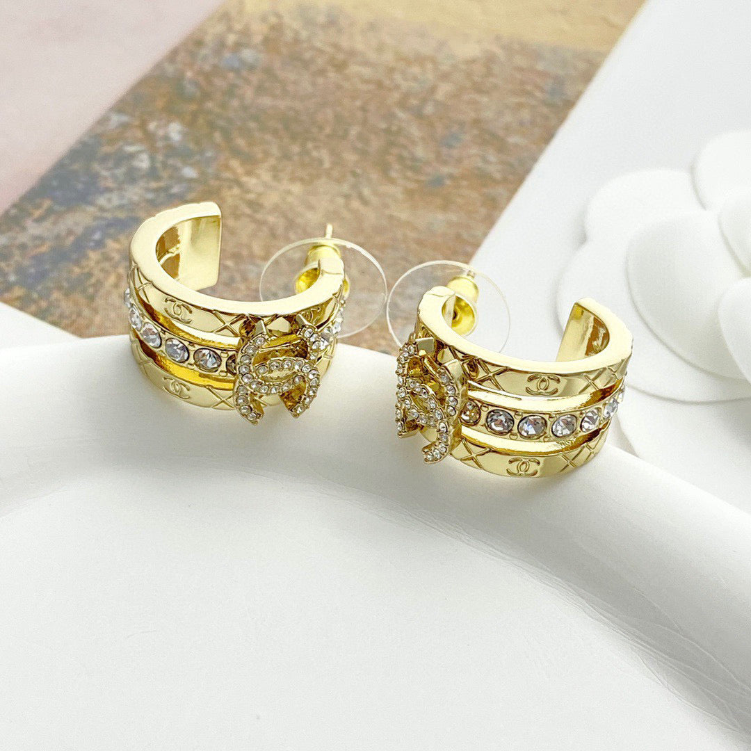 Martin Graham stud earrings in polished metal-tone – front product view