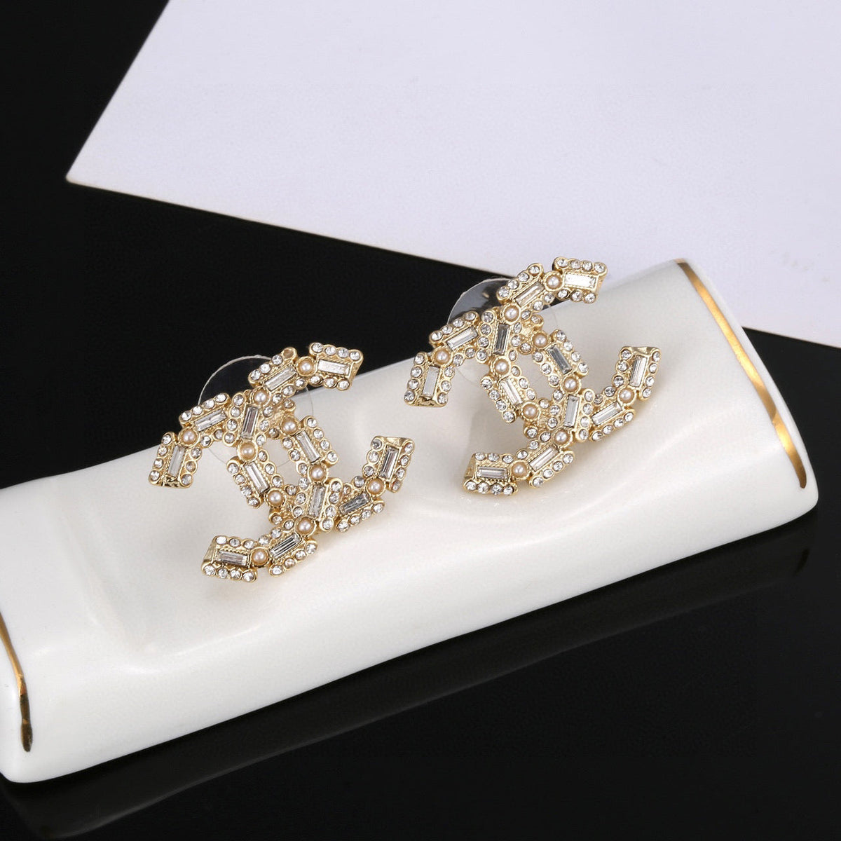 Martin Graham stud earrings in polished metal-tone – front product view