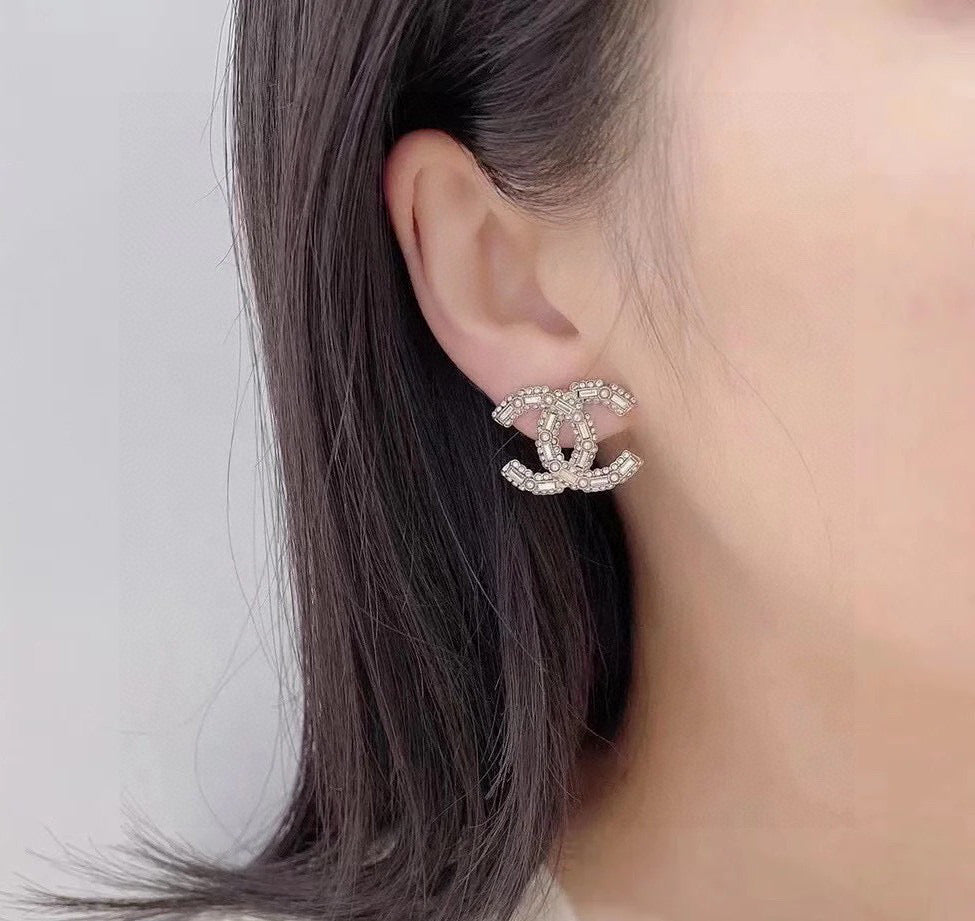 Martin Graham stud earrings in polished metal-tone – styled product view