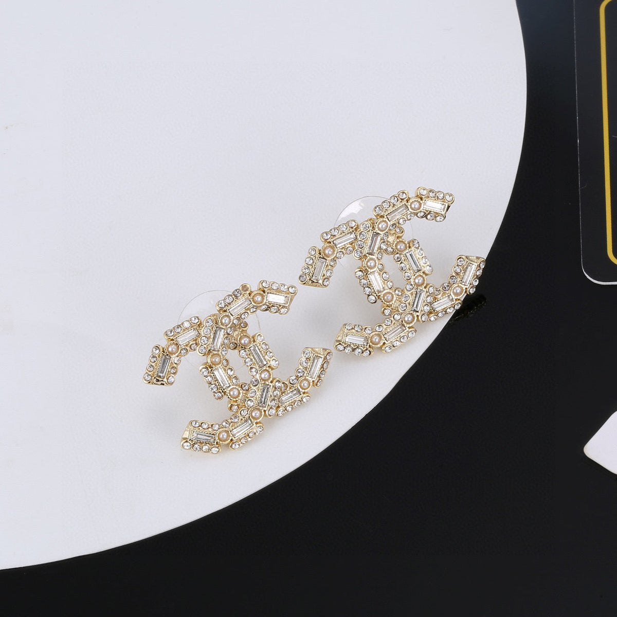 Martin Graham stud earrings in polished metal-tone – detail view
