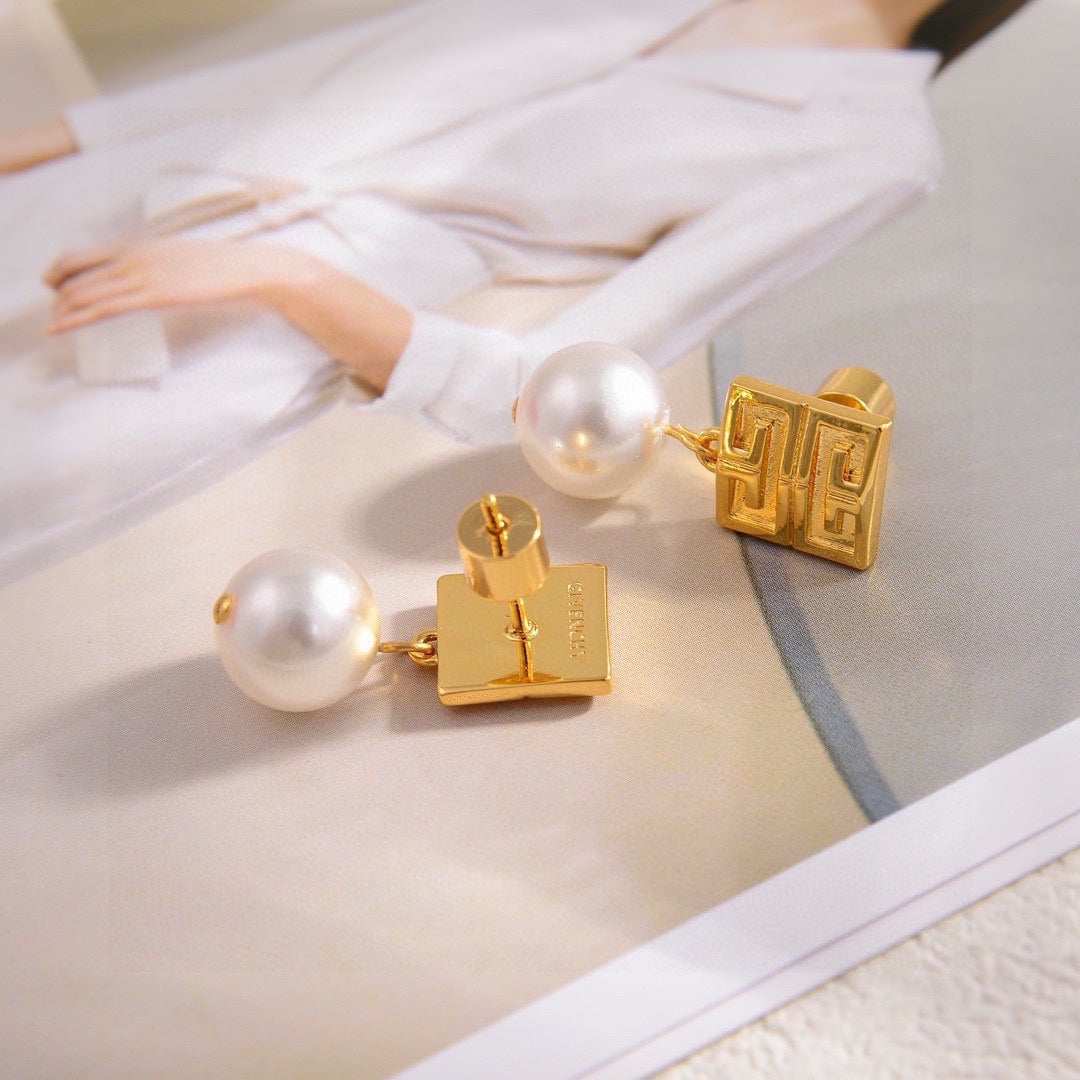 Martin Graham stud earrings in polished metal-tone – close-up detail