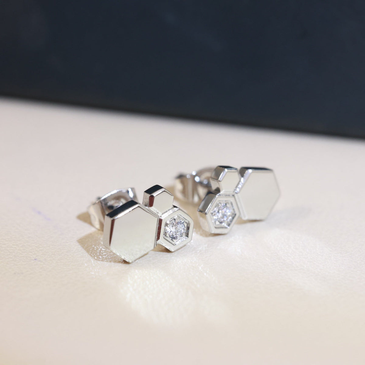 Martin Graham stud earrings in polished metal-tone – front product view