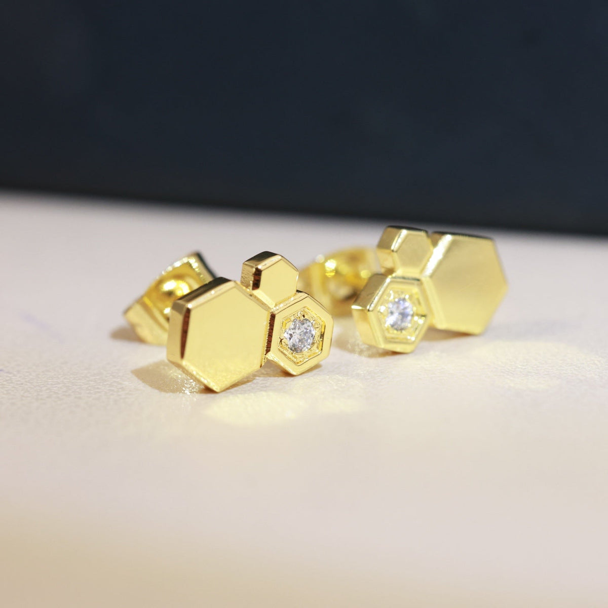 Martin Graham stud earrings in polished metal-tone – detail view