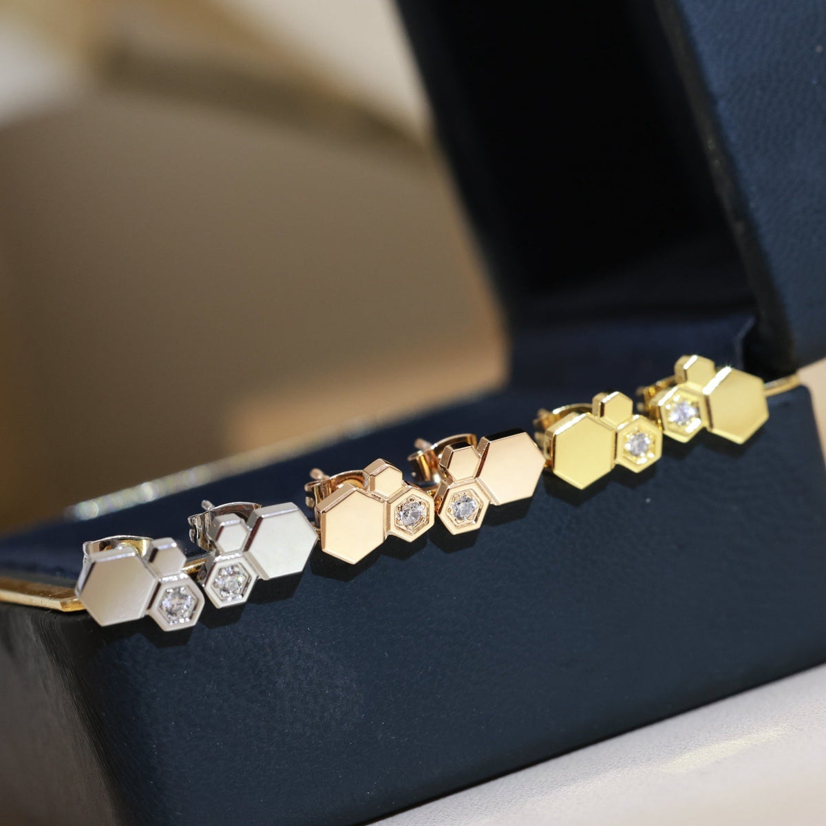 Martin Graham stud earrings in polished metal-tone – styled product view