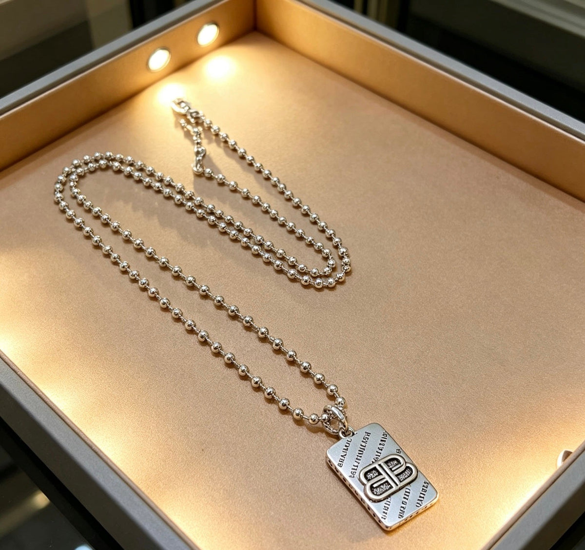 Martin Graham pendant necklace in polished metal-tone – side detail