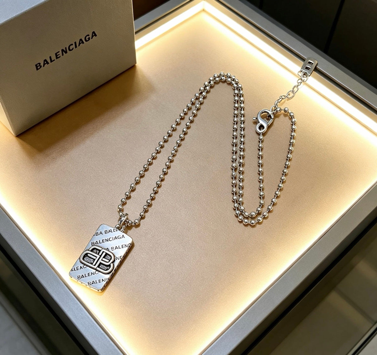 Martin Graham pendant necklace in polished metal-tone – close-up detail