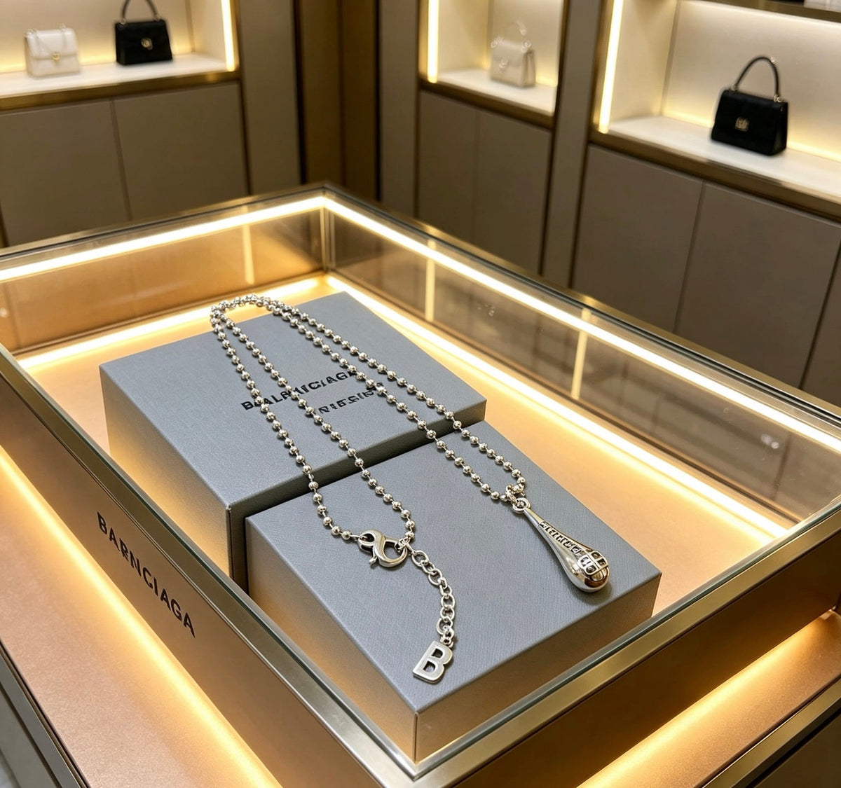 Martin Graham pendant necklace in polished metal-tone – detail view