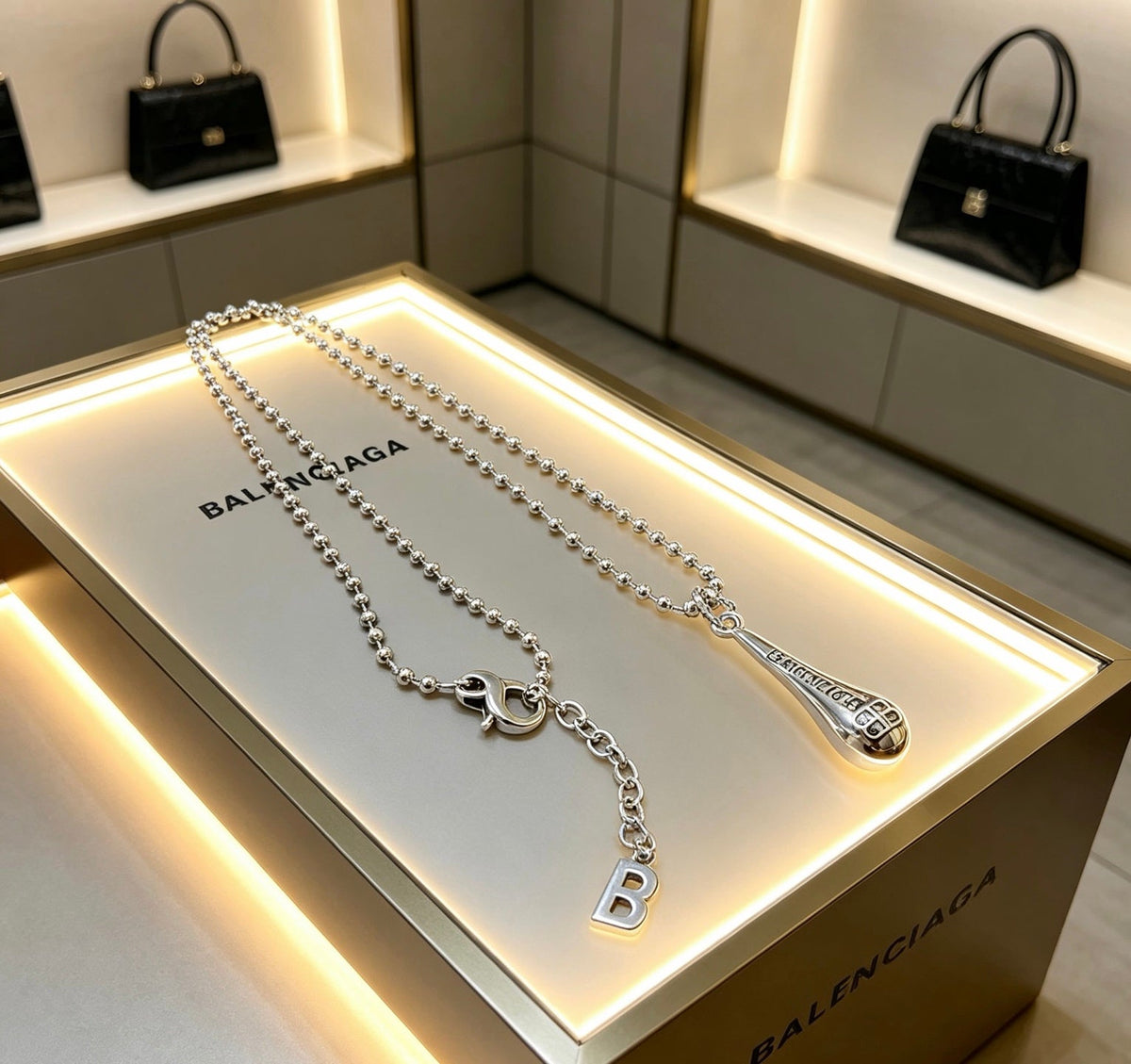 Martin Graham pendant necklace in polished metal-tone – styled product view