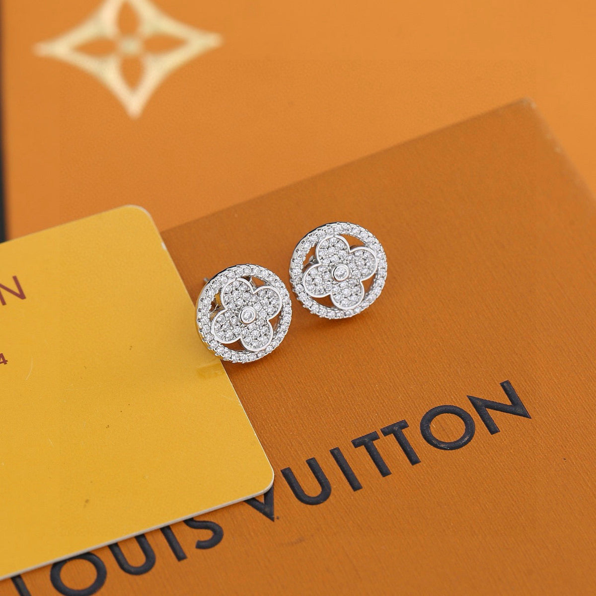Martin Graham stud earrings in polished metal-tone – close-up detail