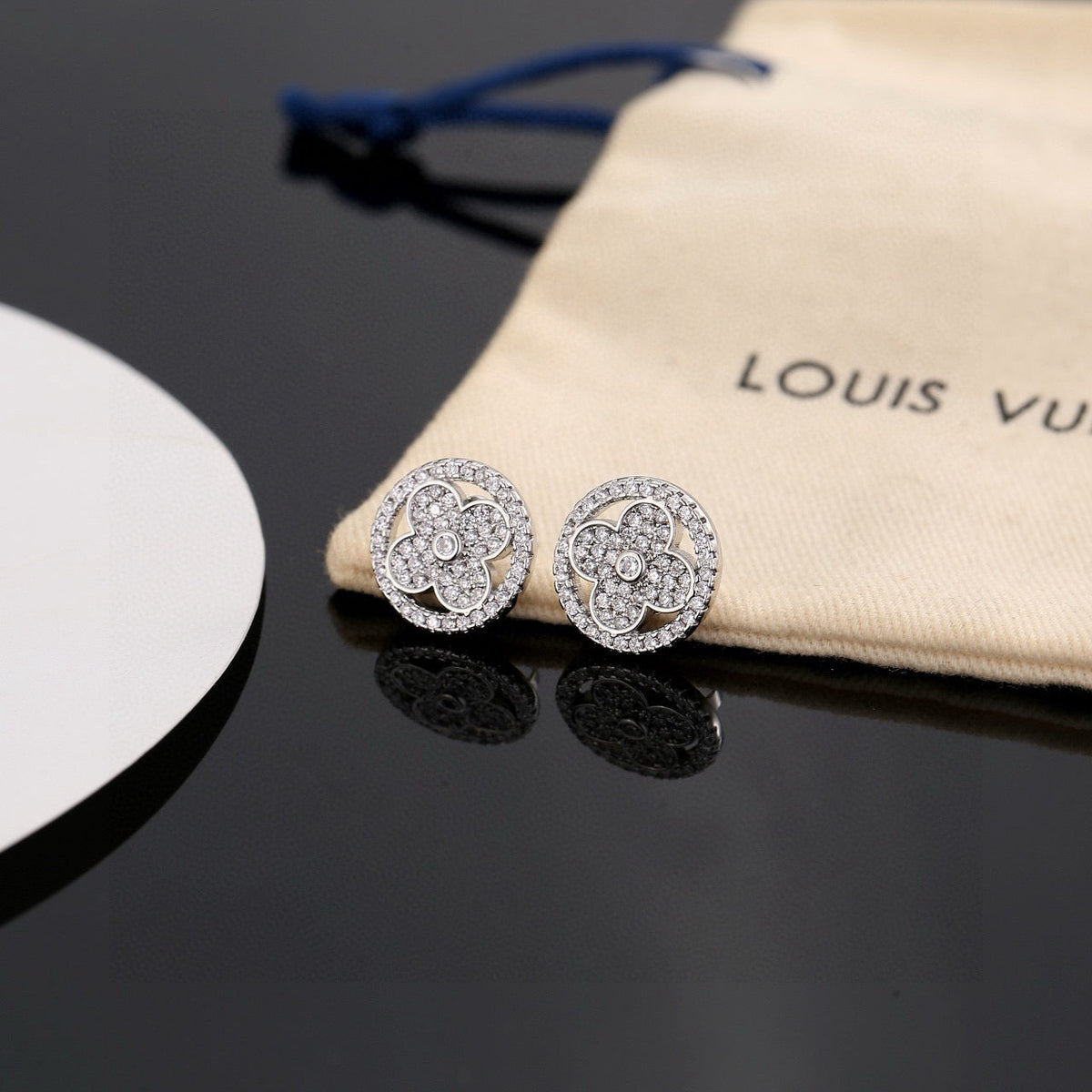 Martin Graham stud earrings in polished metal-tone – detail view