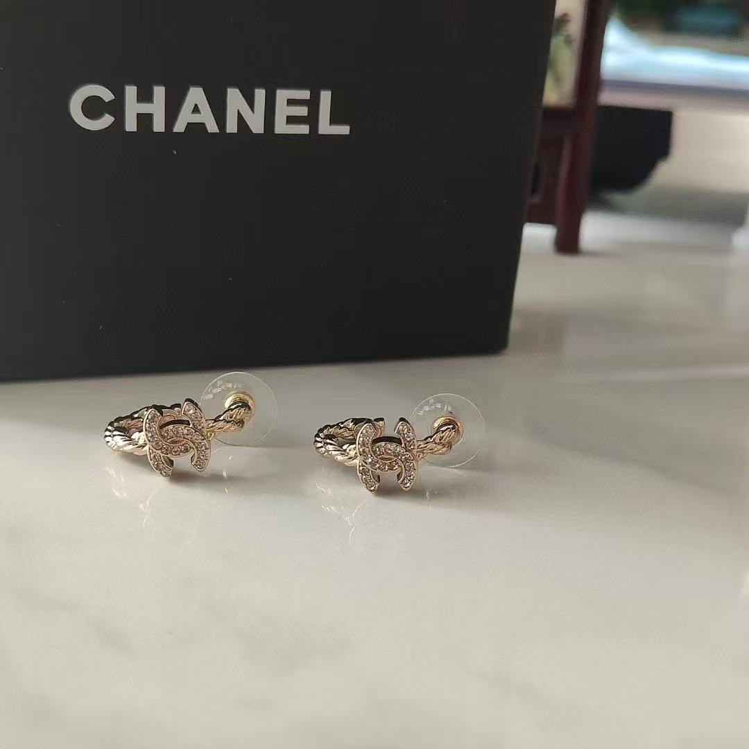 Martin Graham stud earrings in polished metal-tone – close-up detail