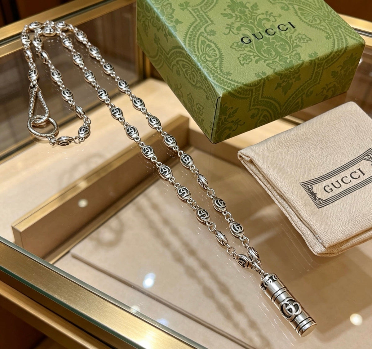 Martin Graham pendant necklace in polished metal-tone – close-up detail