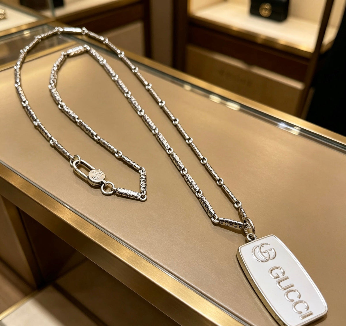Martin Graham pendant necklace in polished metal-tone – detail view