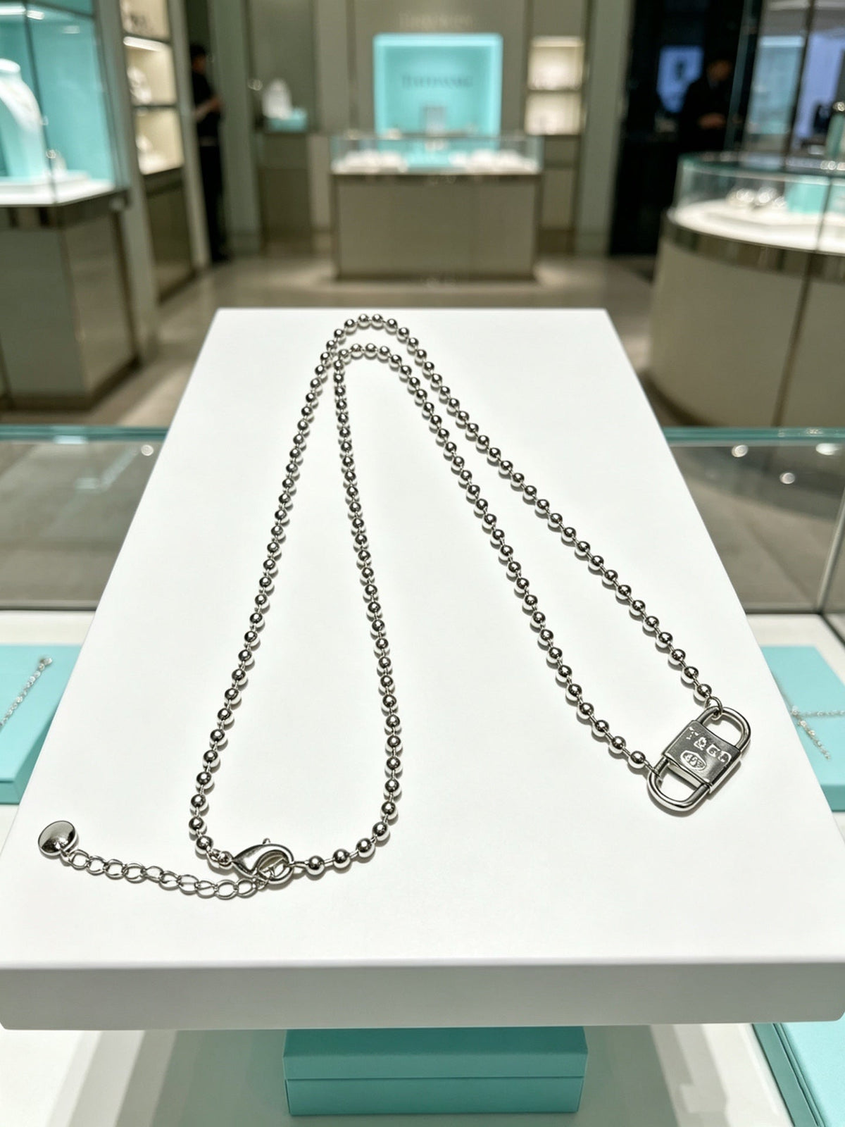 Martin Graham pendant necklace in polished metal-tone – close-up detail