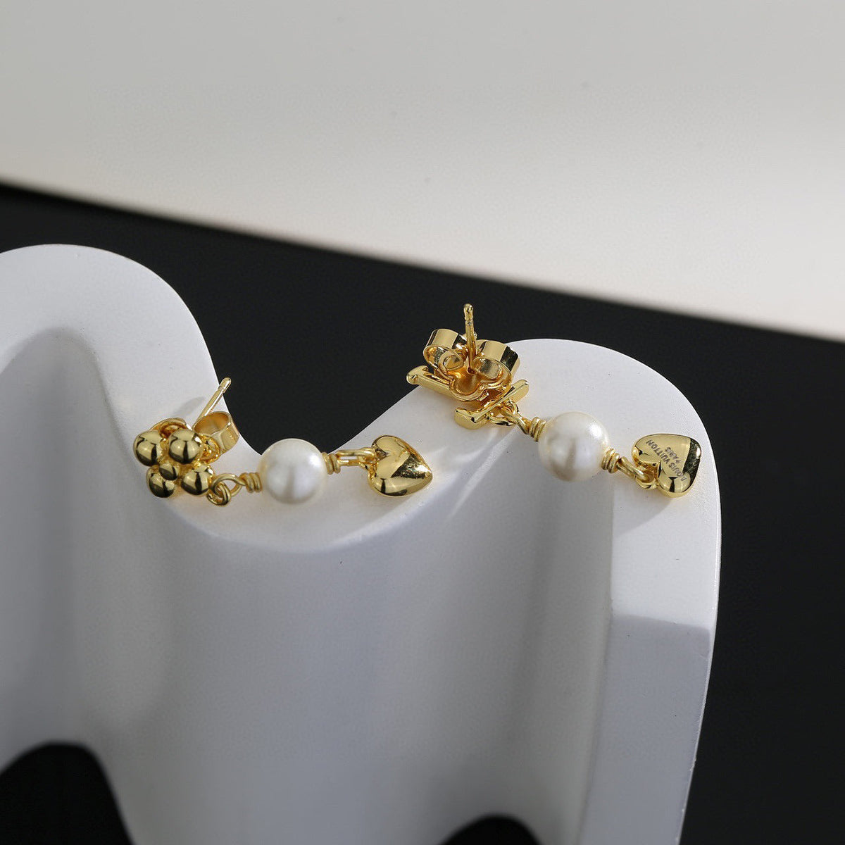Martin Graham stud earrings in polished metal-tone – styled product view