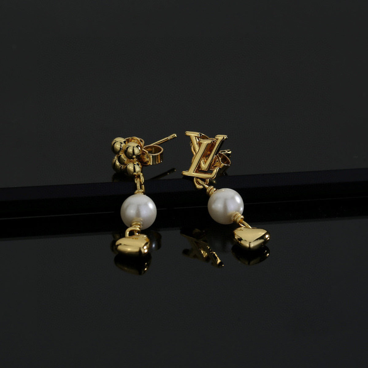 Martin Graham stud earrings in polished metal-tone – front product view