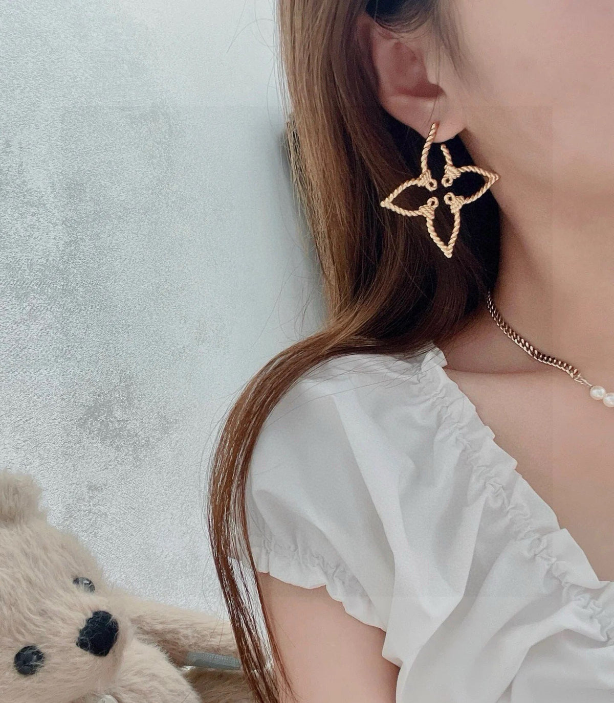 Martin Graham stud earrings in polished metal-tone – detail view