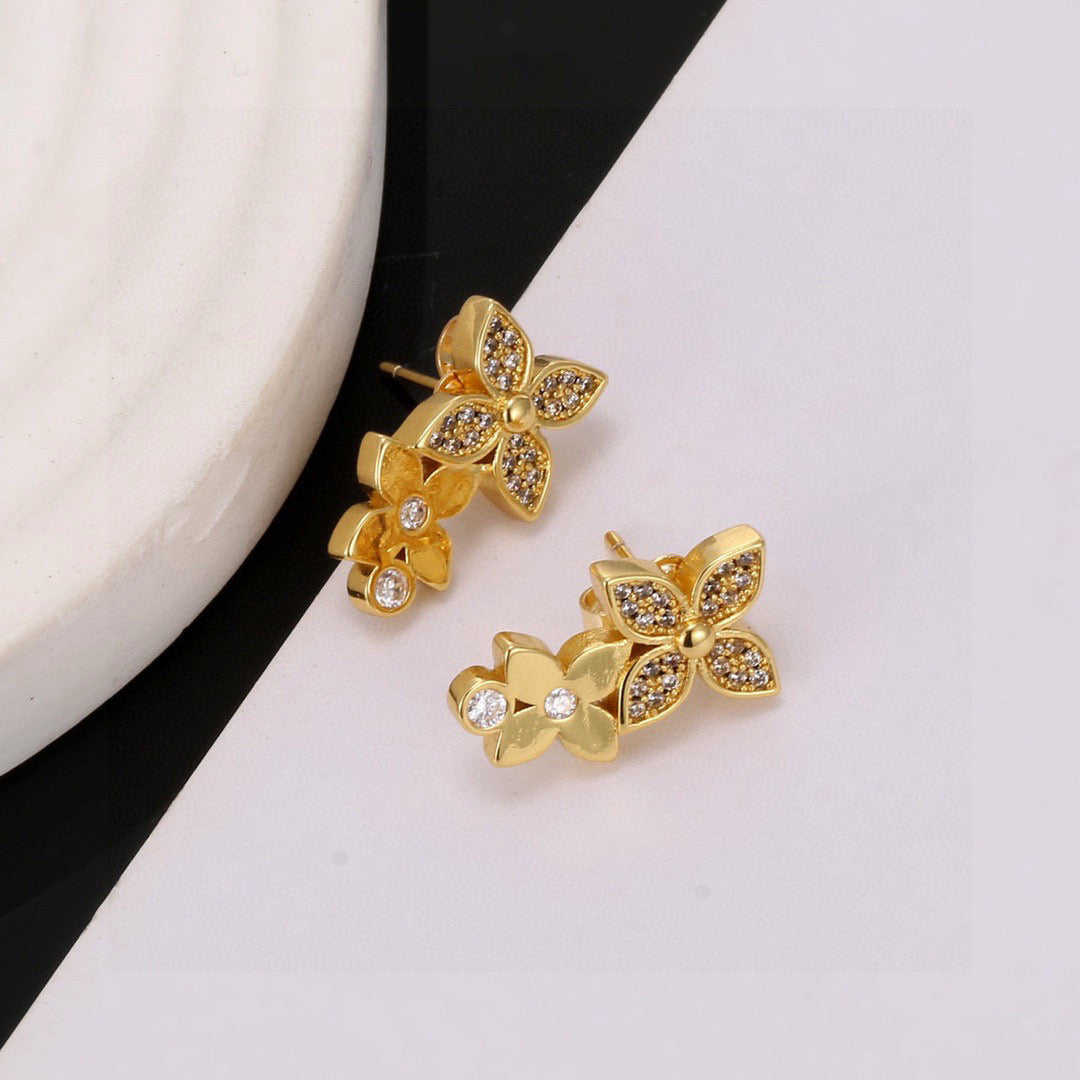 Martin Graham stud earrings in polished metal-tone – close-up detail