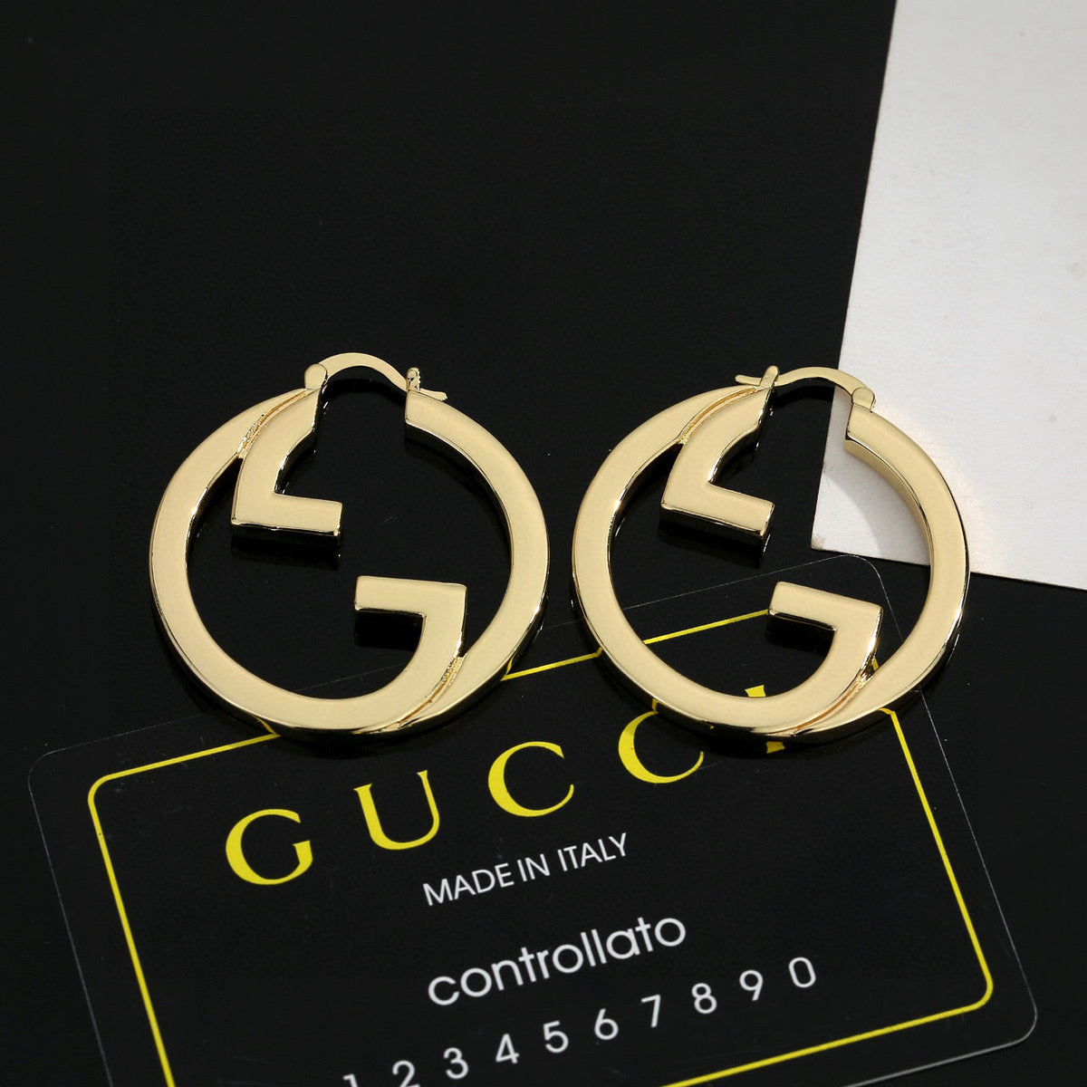 Martin Graham stud earrings in polished metal-tone – front product view