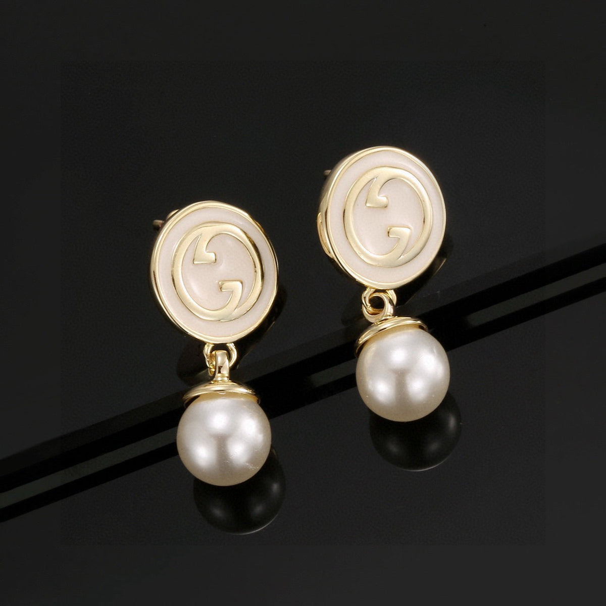 Martin Graham stud earrings in polished metal-tone – styled product view